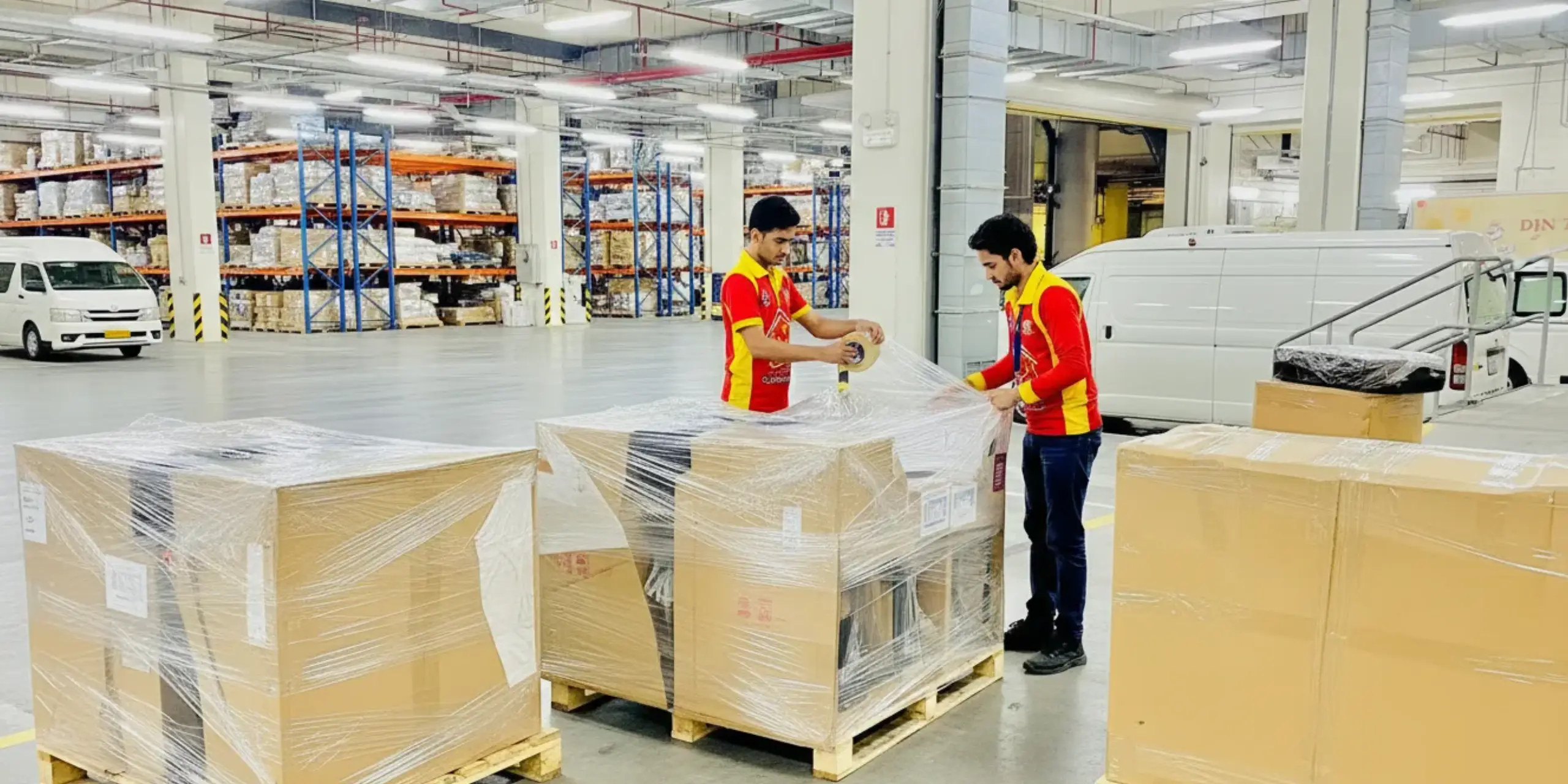 Packed furniture on pallets in the Al Fajer Movers storage warehouse